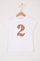 A white cotton birthday t-shirt with the number 2 sewn on the front cut from liberty Nell Annie and May fabric