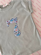 a sage green kids t-shirt with a number 7 on the front cut from Liberty Quey zoo animal print.