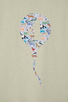 Balloon-shaped number '4' with animal pattern on a beige background