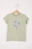 a sage green t-shirt with a colourful number balloon design made from animal liberty print 