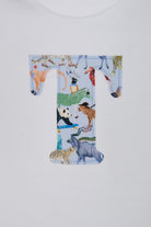 A close-up of a white baby grow personalised with a large letter 'T' printed with a Liberty quey 2  safari animal pattern, including a zebra, giraffe, panda, and cheetah, on a white background.