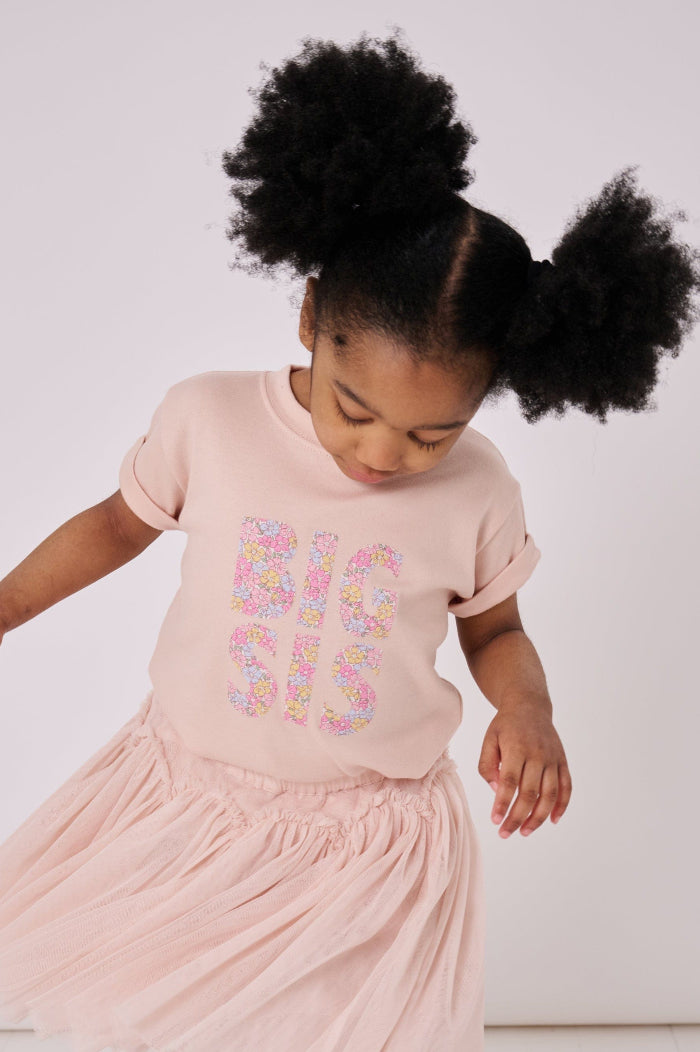 A girl wearing a BIG SIS pale Pink T-Shirt in Choice of Liberty Print as a proud big sister