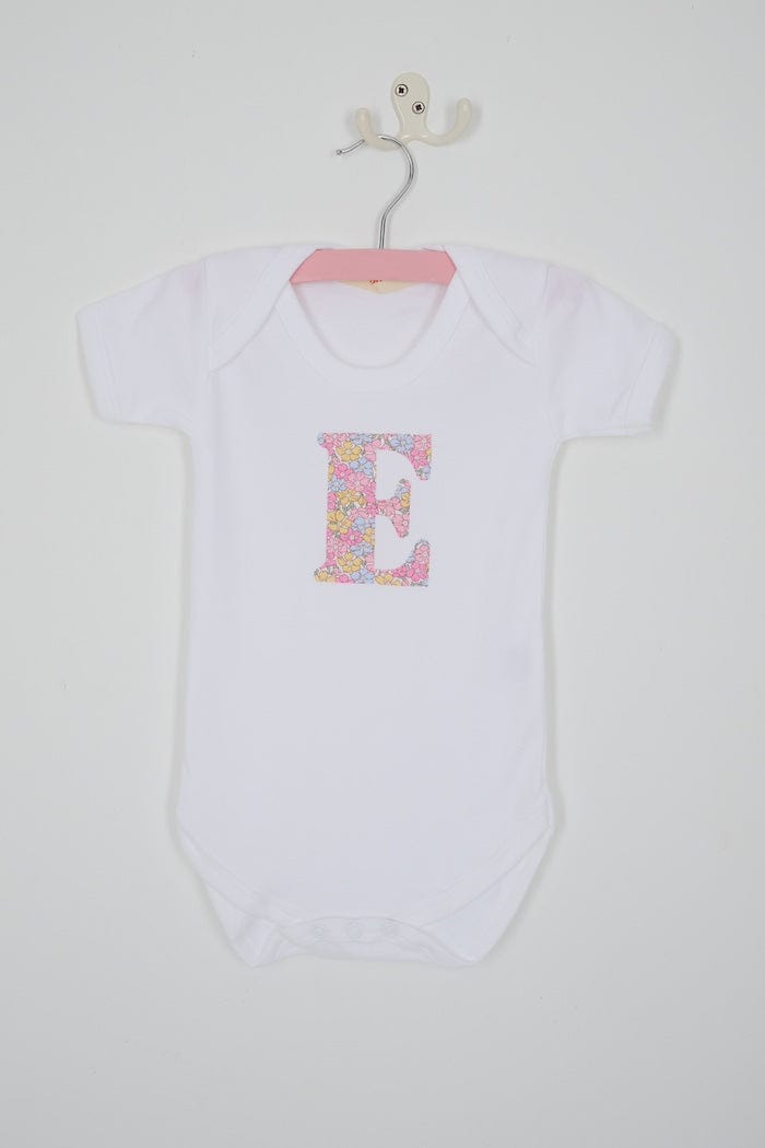 a personalised bodysuit baby grow with an initial cut from floral sadie roseLiberty print 