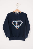 a personalised navy blue sweatshirt with an initial superhero logo on the front in Quey 2 animal liberty print