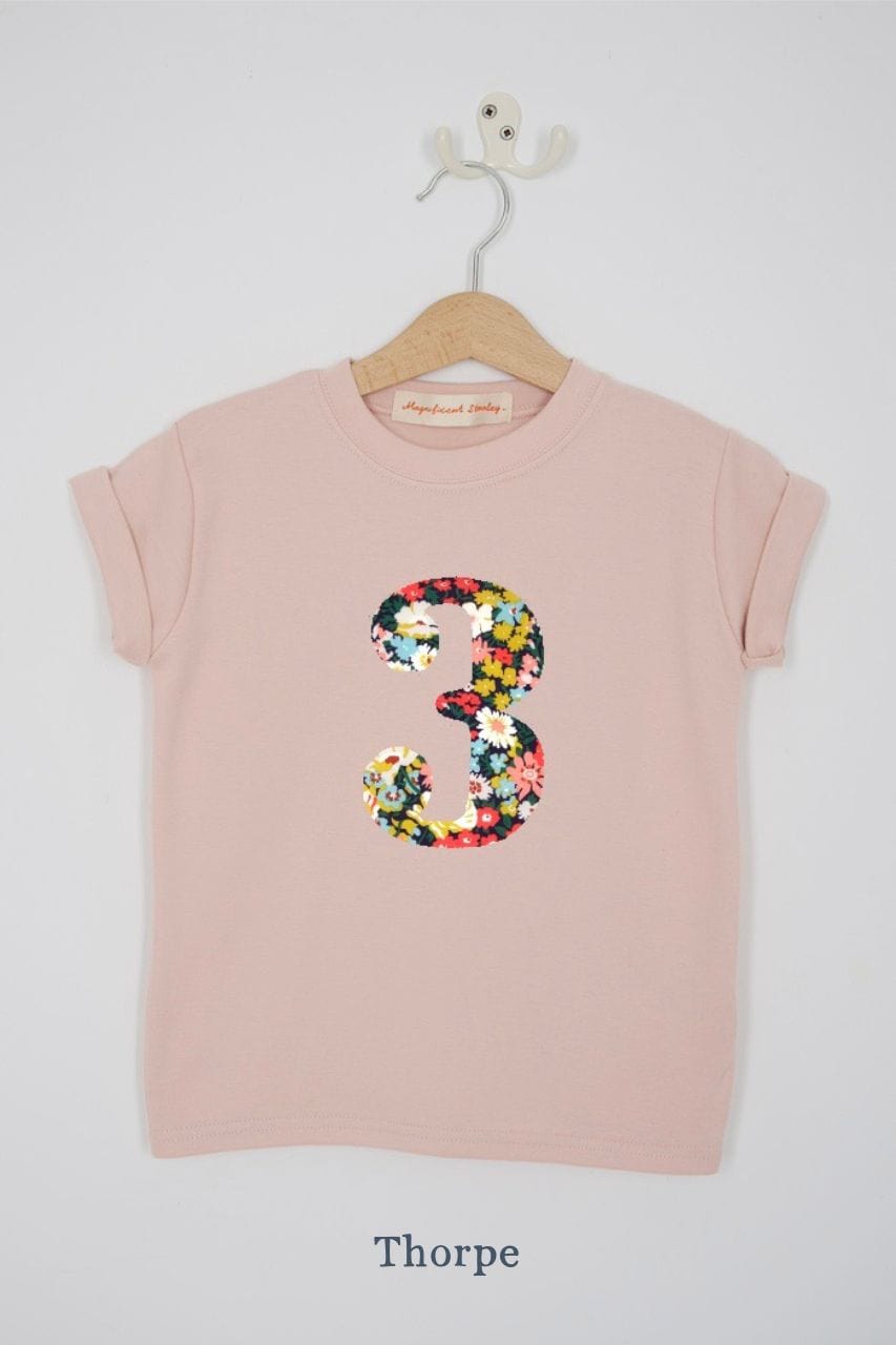 a pink 3rd birthday t-shirt with a number 3 cut from thorpe floral liberty print on the front