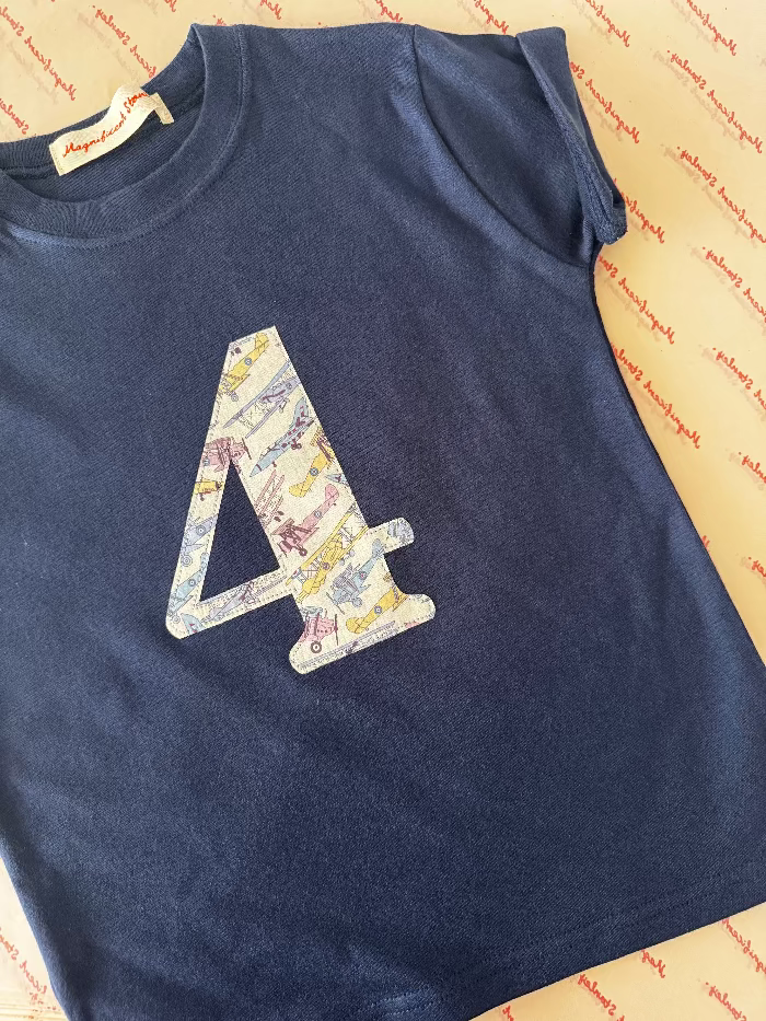 A kids navy t-shirt with the number 4 on the front in Liberty Jet plane fabric