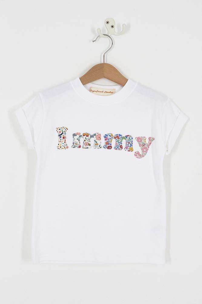 A close up of a personalised white t-shirt with her name on in a mix of Liberty prints.
