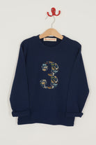 A navy long sleeve t-shirt with a  number 3 on the front on in Liberty Quey Zoo animal print fabric.