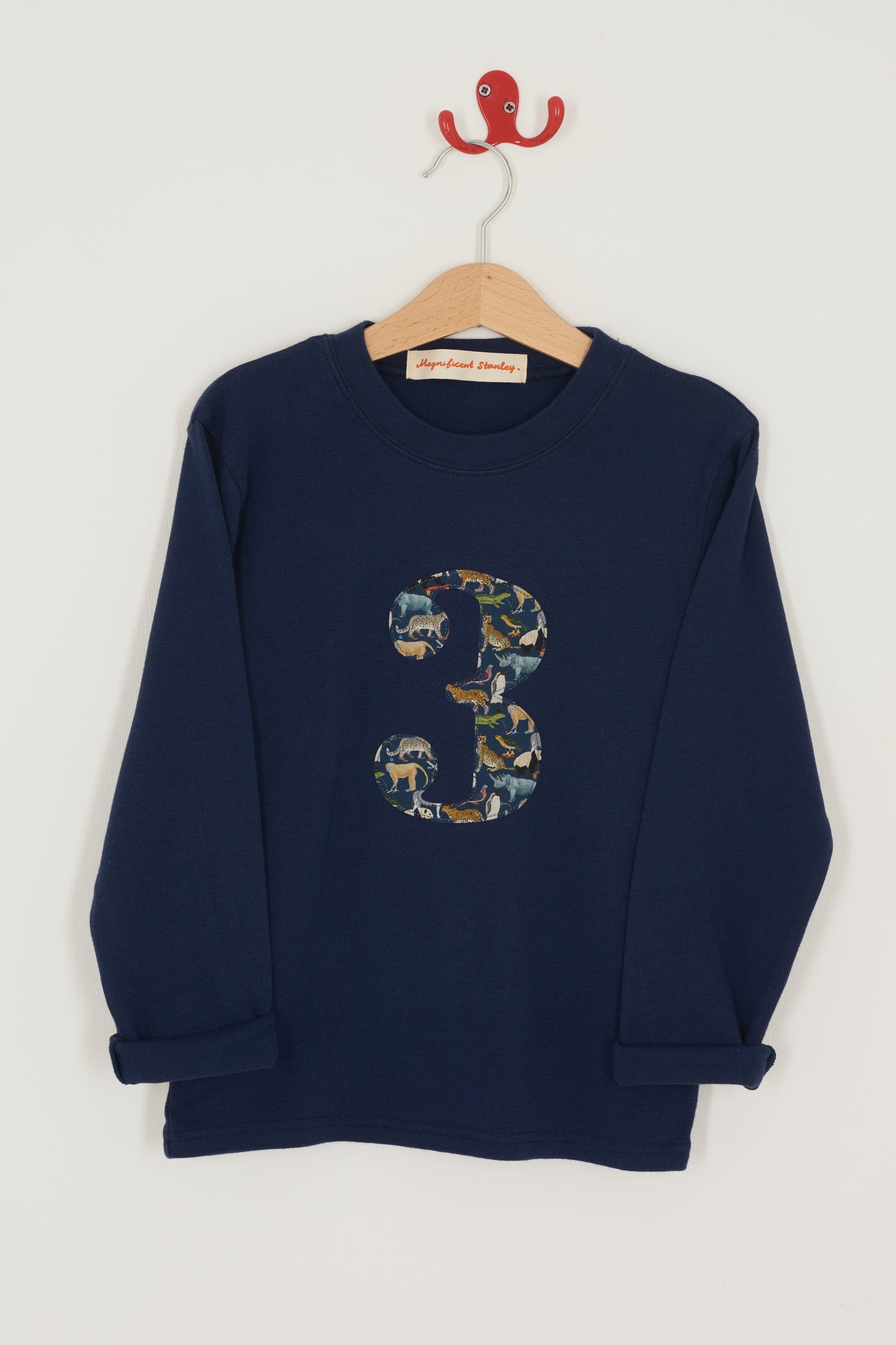 A navy long sleeve t-shirt with a  number 3 on the front on in Liberty Quey Zoo animal print fabric.
