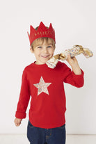 a smiling 5 year old boy wearing a Magnificent Stanley Red star kids Christmas T-Shirt in Adelajda Liberty Print