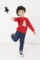 a 5 year old boy wearing a Magnificent Stanley Tee Red Tree kids Christmas T-Shirt in Adelajda Liberty Print