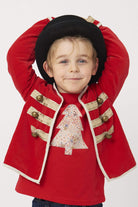 a 5 year old boy wearing a Magnificent Stanley Tee Red Tree kids Christmas T-Shirt in Adelajda Liberty Print