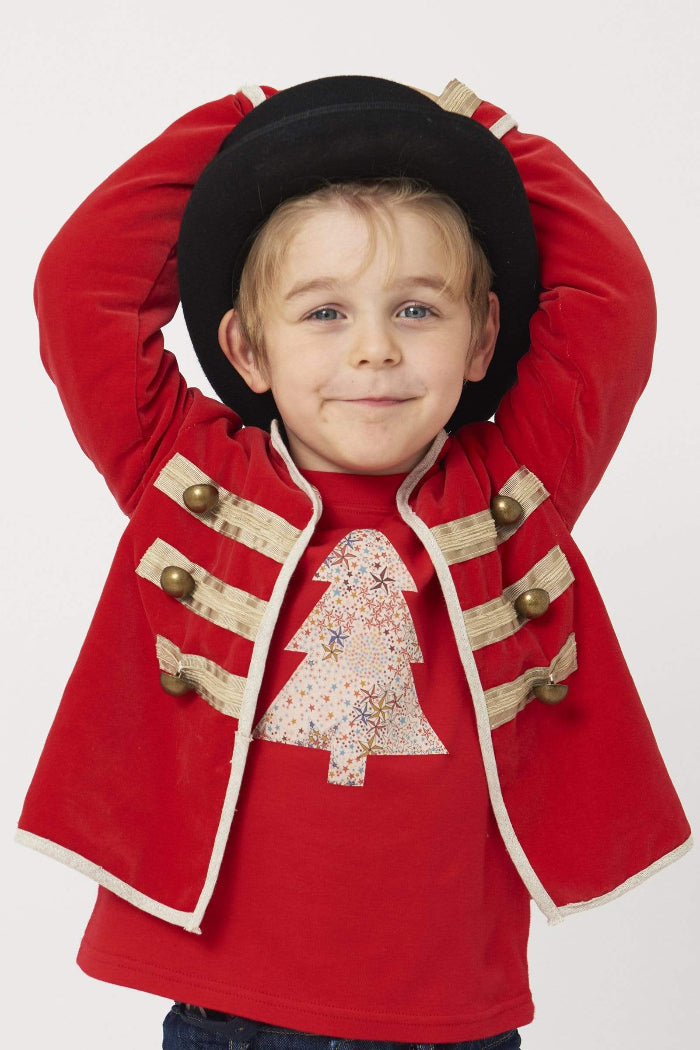 a 5 year old boy wearing a Magnificent Stanley Tee Red Tree kids Christmas T-Shirt in Adelajda Liberty Print