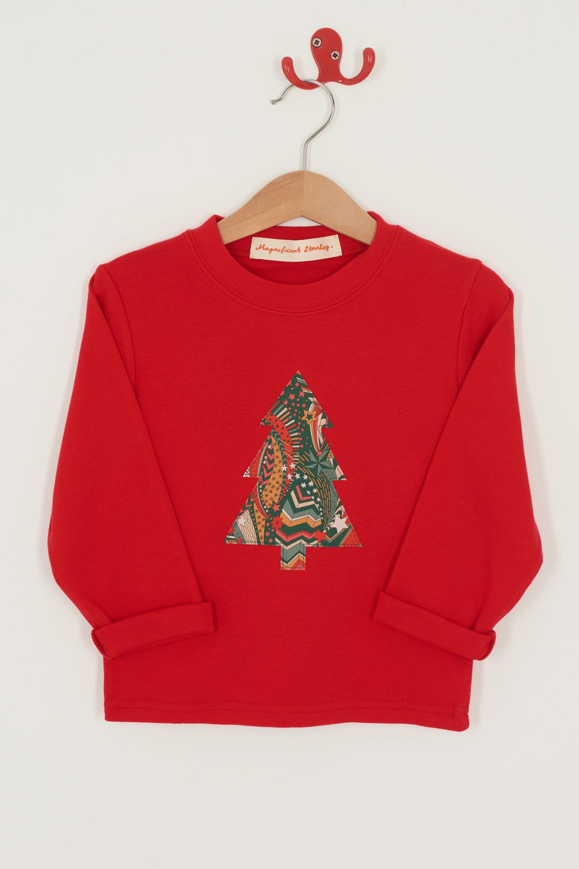 A festive red cotton t-shirt with a Christmas tree made from a stray liberty print on the front. 